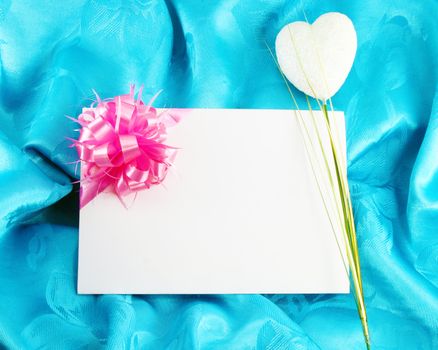 gift card with ribbon on blue satin