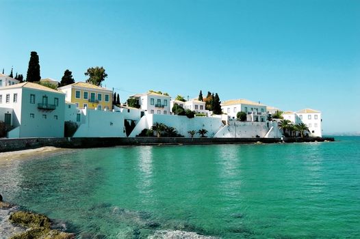 Beach houses and palm trees on the Greek island