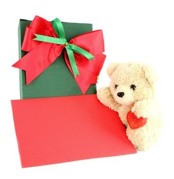 Teddy bear and card and gift on white background