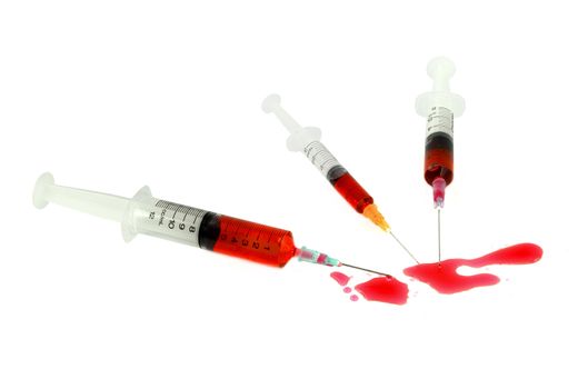 three syringe with blood on a white background