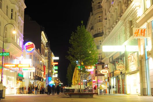 Vienna, Austria - September 23, 2012: Vienna city centre with many tourists at night . Tourism generated 8.4% of Austrian gross domestic product (23.6 billion Euros) and provided 181 thousand jobs