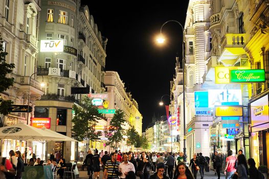 Vienna, Austria - September 23, 2012: Vienna city centre with many tourists at night . Tourism generated 8.4% of Austrian gross domestic product (23.6 billion Euros) and provided 181 thousand jobs