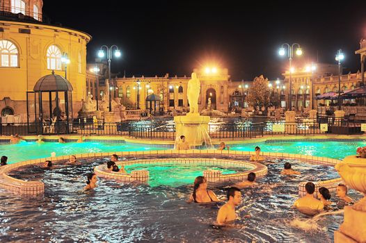 Budapest, Hungary -  October 01, 2012: People have a thermal bath in the Szechenyi spa . Szechenyi Medicinal Bath is the largest medicinal bath in Europe. The built-up area are 6,220 square meter.