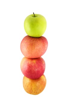 Fresh red apples stacked on top of one another with a green apple on top