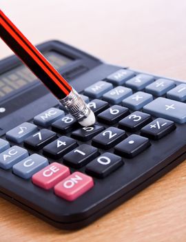 pencil and a calculator on the desk