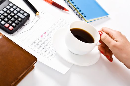 female officer holding white coffee cup during working time at office.