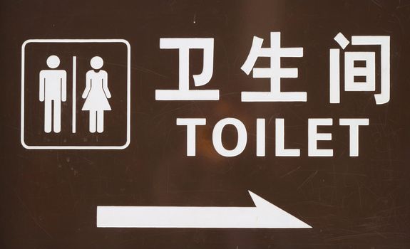 A sign outside public toilet in Beijing with writing in English and Chinese.