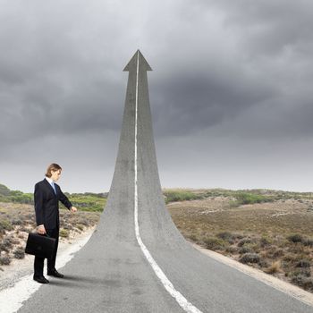 Concept of the road to success with a businessman standing on the road