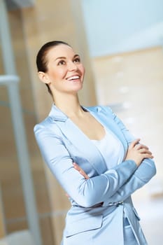 Portrait of happy smiling young businesswoman in office