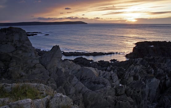 Onique rock formation on a beaqch at sunset