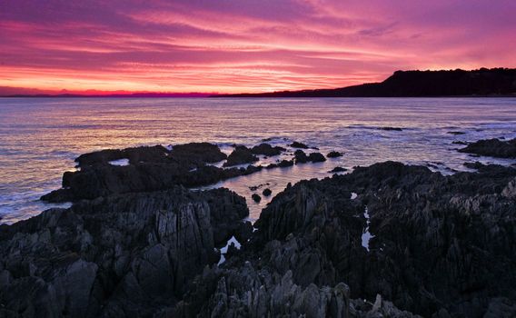 Onique rock formation on a beaqch at sunset