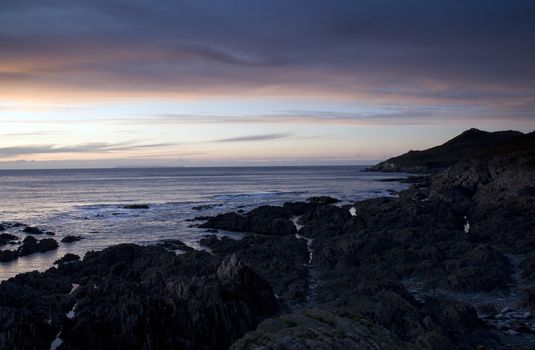 Onique rock formation on a beaqch at sunset