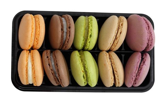 Upper view of a tray with various macarons isolated against a white background with clipping path included in the file.