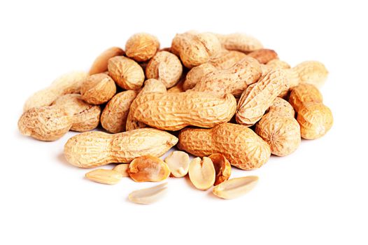 Pile of groundnuts on a white background