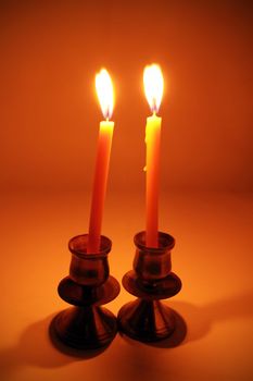 burning candle with antique metal candlestick