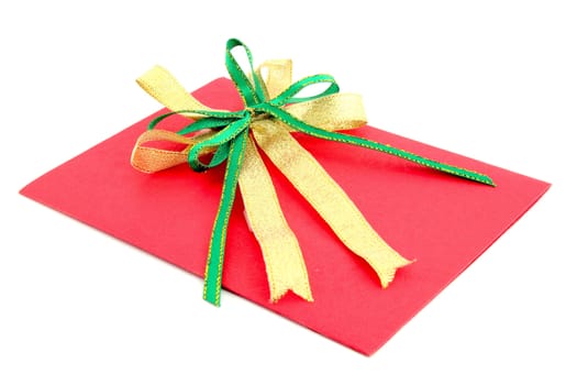 red gift card with green and yellow bow on white background