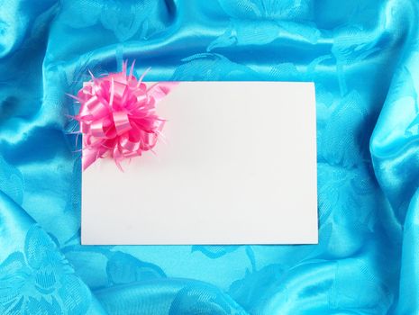 gift card with ribbon on blue satin