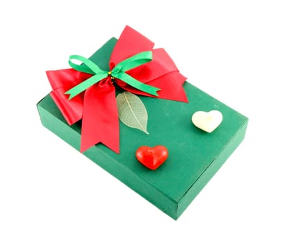 green gift box with red ribbon on white background