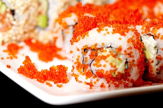 Macro shot of the California roll on a white plate. Shallow dof.