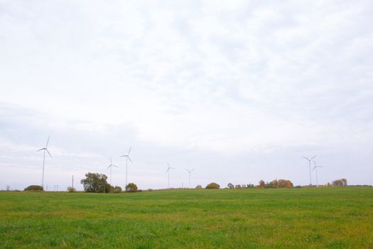 Wide shot of the wind turbines in the field.
