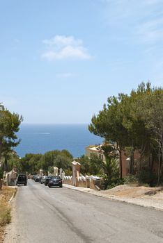 View of blue sky,  ocean and street in town, Majorca, Spain