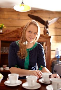 Young beautiful woman is making coffee in country house.