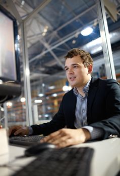 Attractive young man is working in the bank. Shallow depth of field.