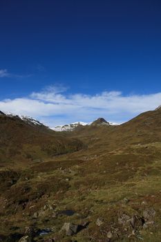 Early Norwegian mountain landscape with snow on peaks