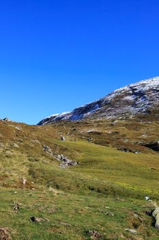 Early Norwegian mountain landscape with snow on peaks