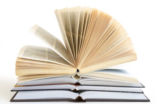 Stack of open old fanned hardcover leather bound books