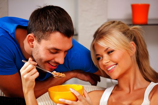 bright picture of happy couple with muesli (focus on woman)