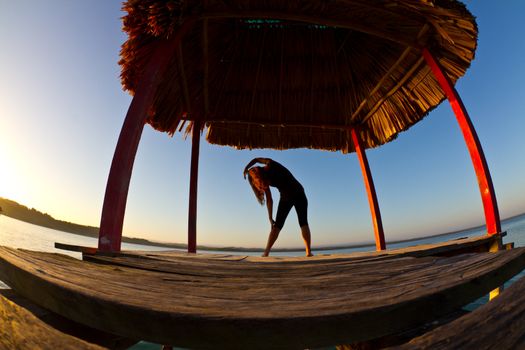 A young woman exercises in the early hours