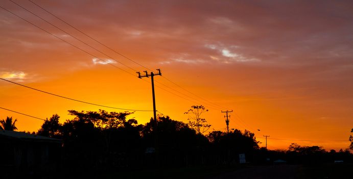 The sun sets over a remote town in Belieze.