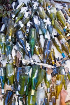 thousands of glass wine bottles wait to be recycled