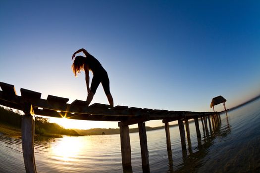 early morning yoga on the jetty by the lake.