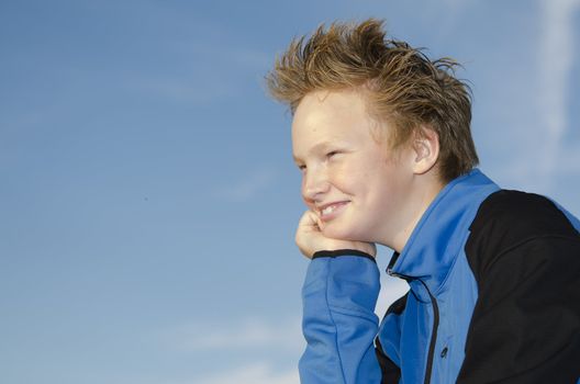 Portrait of guy with spiky hairstyle against blue sky background