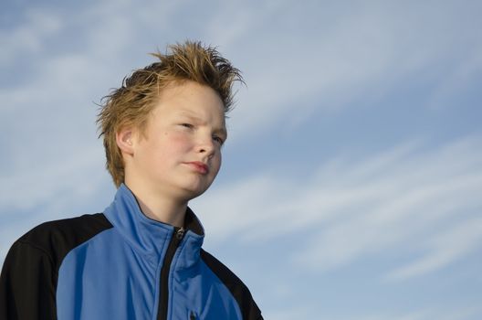 Portrait of guy with spiky hairstyle against blue sky