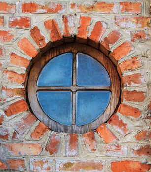 Round window on brick wall on castle. Dubno, Ukraine