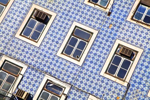 Lisbon windows. Wall with blue title and windows