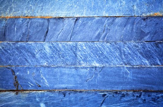 Close up of a blue brick-wall, texture background. Pattern of cracked real stone wall surface with cement