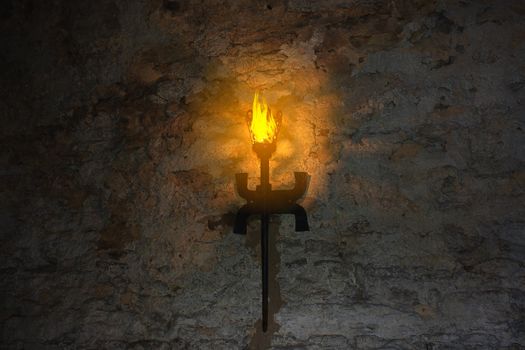 torch on the wall of an old castle. Dubno, Ukraine