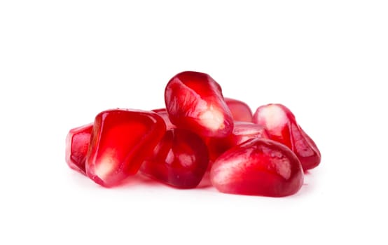 Macro view of ripe seeds of pomegranate over white background