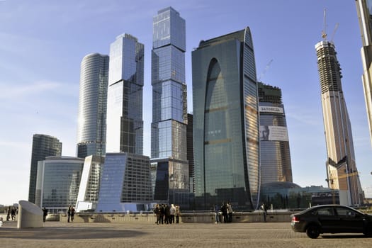 Moscow, Russia - October 22, 2011 : people resting and watching to the towers of modern Moscow International Business Center.