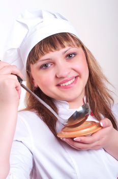 attractive woman keeps a ladle, white background