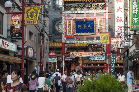 Yokohama, Japan - August 3, 2008:  people crowds walk inside famous Chinatown district in Yokohama. This area is pedestrian streets with many shops and restaurants, this district is known as largest Chinatown in Japan and in Asia.
