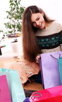 Cute and Attractive woman checking shopping bags at home
