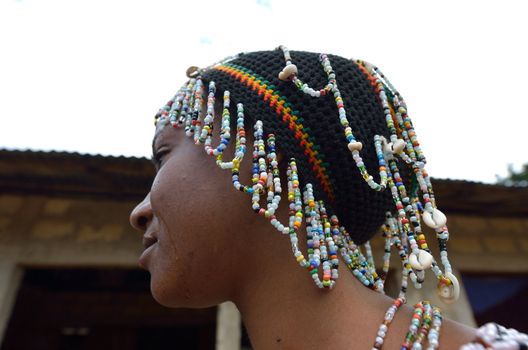 Kartiak,Senegal-September 18,2012 :African woman with the typical hat to go to the ritual of Boukoutt of Initiation ceremony on September 18, 2012 in Kartiak, Senegal. The ceremony occurs every 30 years and celebrates boys becoming men.