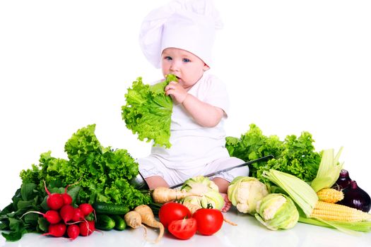 Baby cook with fresh vegetables isolated on a white