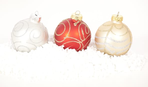 Red and gold Christmas baubles on golden background