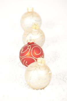 Red and gold Christmas baubles on golden background